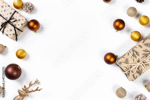 Christmas and new year holiday background. Christmas gifts with balls, pine cones and spruce branches on white background top view. Flat lay. Xmas greeting card concept