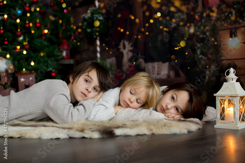 Happy family with children and pet dog, enjoying Christmas time together, celebrating