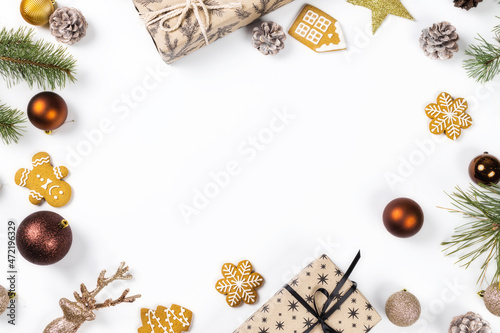 Frame of christmas gifts with balls, pine cones and spruce branches on white background top view. Flat lay. Christmas and new year holiday background. Xmas greeting card concept