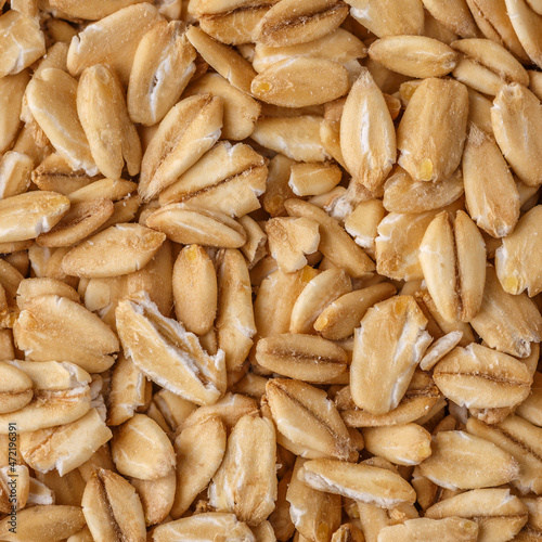Rolled oat, oat flakes background or texture. Close up, directly above.Heap of dry rolled oats isolated.