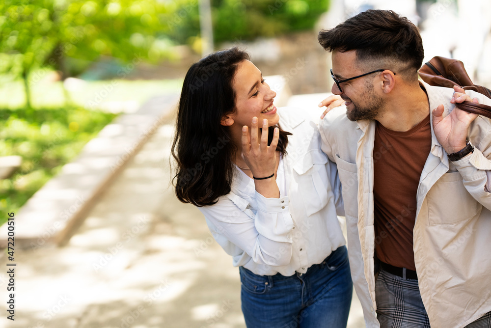 Happy young couple outdoors. Loving couple walking in the city. Happy young couple outdoors. Loving couple walking in the city.