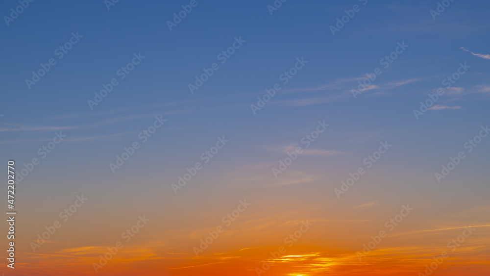 Panorama sunset with blue and golden yellow sky, Amazing purple and orange sky during the sun going down in evening, Horizon nature background.