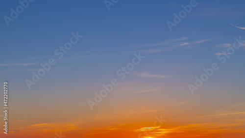 Panorama sunset with blue and golden yellow sky, Amazing purple and orange sky during the sun going down in evening, Horizon nature background.