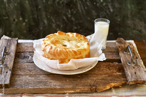 Homemade potato pie. Yeast dough. Wooden background, side view.
