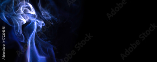 Abstract candle smoke on a black background. Colored fog texture photo