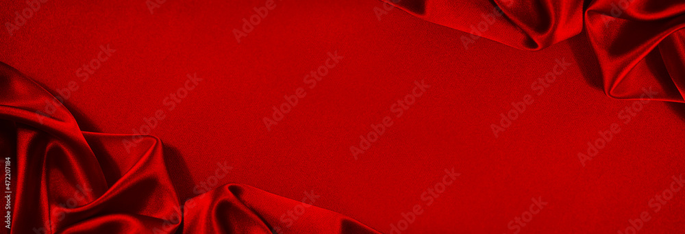 Beautiful red silk satin background. Soft folds on shiny fabric. Luxury  background with copy space for text, design. Wide banner. Flat lay, top  view. Birthday, Christmas, Valentine. Stock Photo