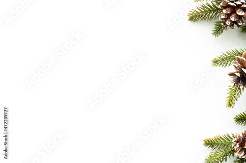 White table with Christmas decoration including pine branches and pine cones. Merry Christmas and happy new year concept. Top view with copy space, flat lay.