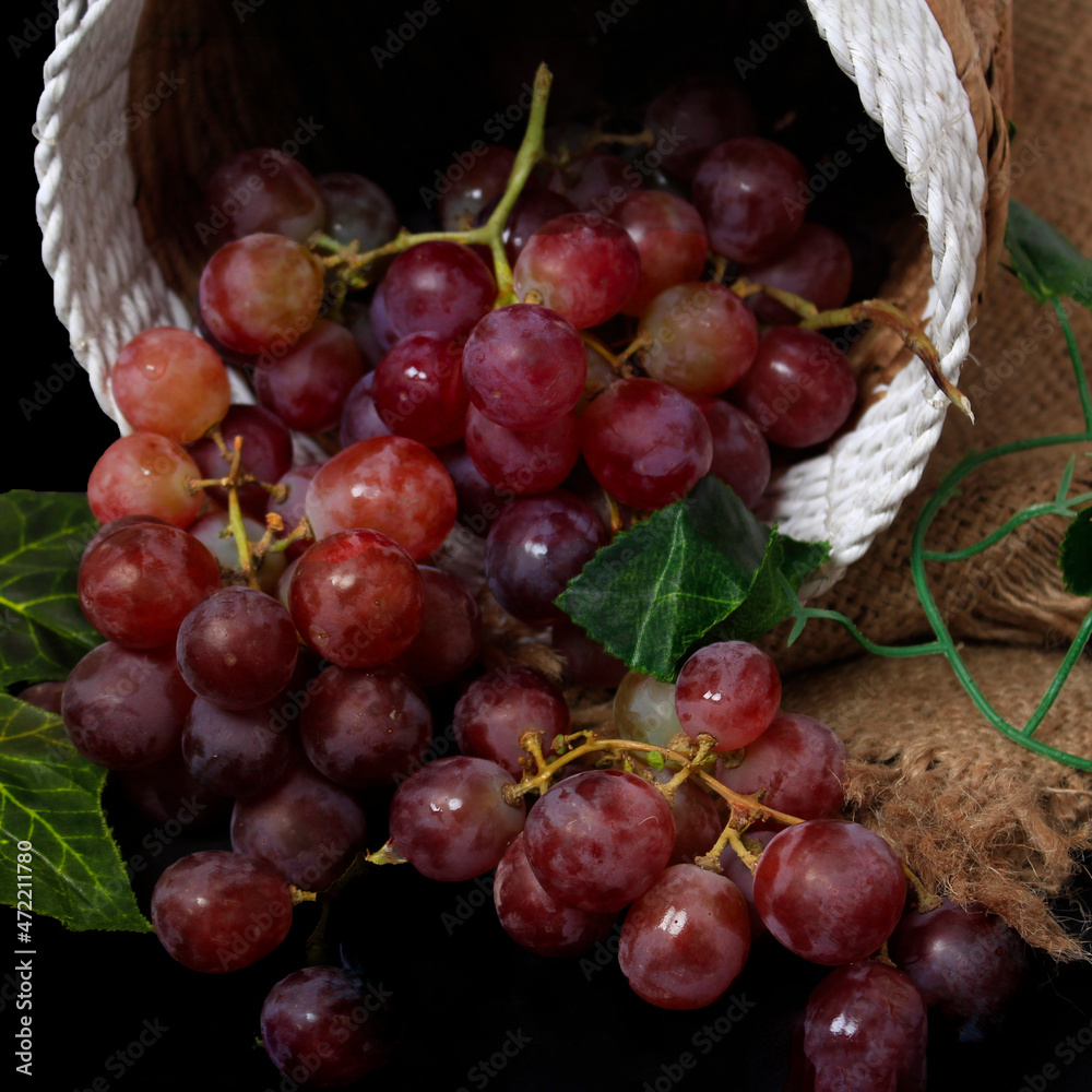 Fototapeta premium Grapes are the fruit of a woody grape vine. Grapes can be eaten raw, or used for making wine, juice, and jellyjam. Grapes come in different colours; red, purple, white. Fokus blur.