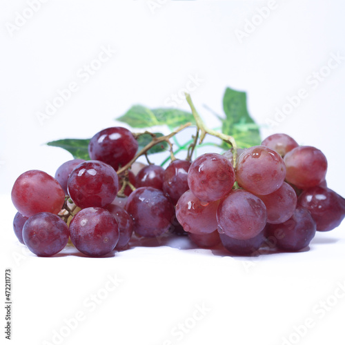 Grapes are the fruit of a woody grape vine. Grapes can be eaten raw, or used for making wine, juice, and jellyjam. Grapes come in different colours; red, purple, white. Fokus blur. photo