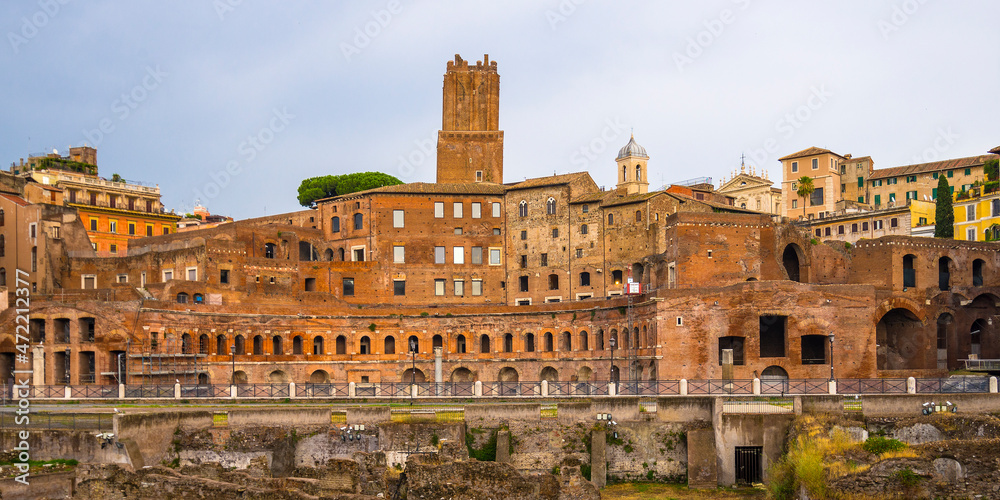 Ancient ruins in front of newer buildings in Rome, Italy