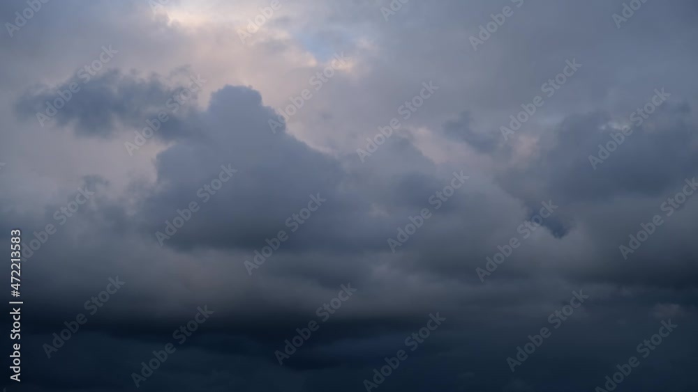 Cloudy sky in autumn. Dark blue cloud background. The sky before a thunderstorm, storm clouds. The concept of bad weather, climate change, impending disaster. Gray-purple cloudy natural background.