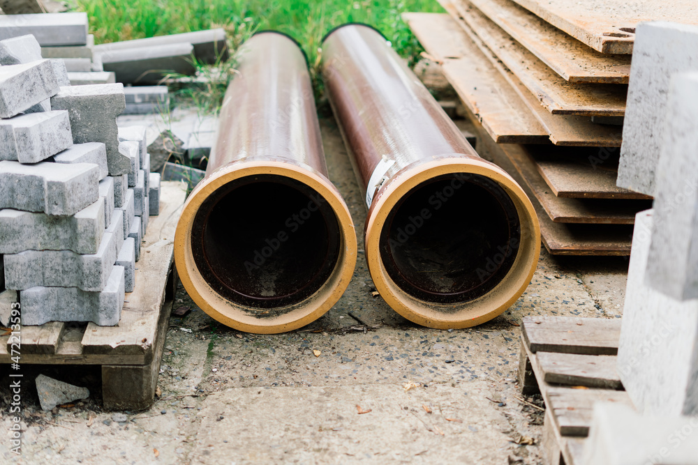 Large sectional sewer pipes, bricks, paves in warehouse construction