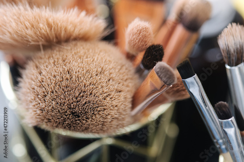 Close-up of makeup brushes in beauty studio