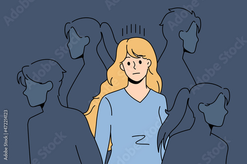 Sad young woman surrounded by people silhouettes feel lonely in society suffer from lack of communication. Upset girl struggle with loneliness and solitude in crowd. Outcast. Vector illustration.