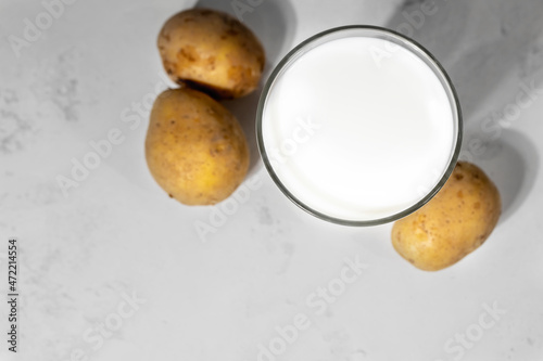 Various vegan vegetable milk, non dairy potato alternative milk, free space for text, flat lay with selective focus photo