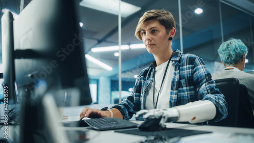 Quadro su tela Diverse Body Positive Office: Portrait of Motivated Woman with Disability Using Prosthetic Arm to Work on Computer