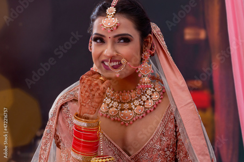 Portrait of a beautiful Indian bride in traditional wedding outfit