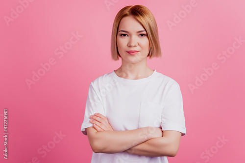 Photo of confident lady crossed hands look camera wear white t-shirt isolated on pink background
