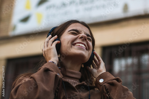 Girl listening to music in her headphones and enjoying