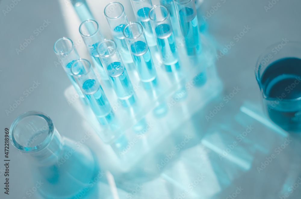Laboratory flasks and test tubes on the table in the rays of sunlight. Laboratory flasks and test tubes on the table in the rays of sunlight.