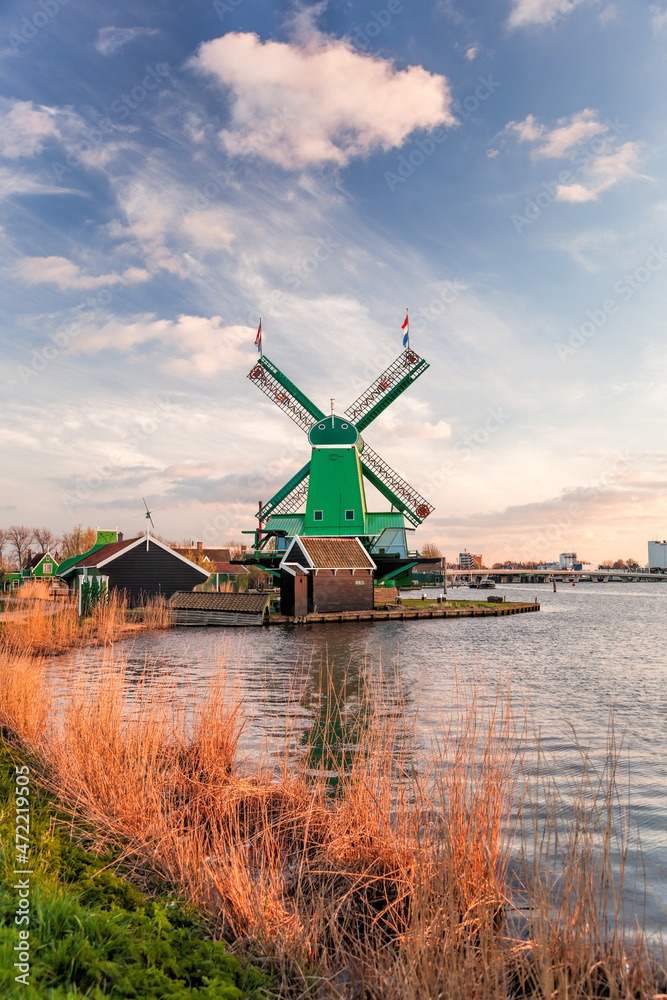 Traditional Dutch windmills against colorful sunset in Zaanse Schans, Amsterdam area, Holland