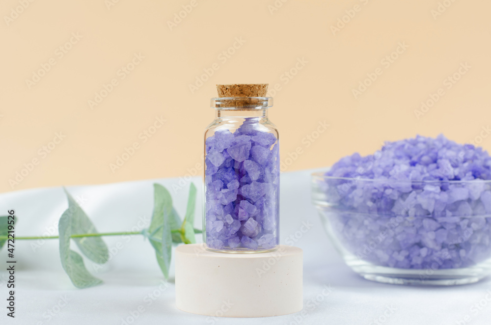 Lavender sea salt in a transparent bottle on a round podium Lavender sea salt in a transparent bottle on a round podium