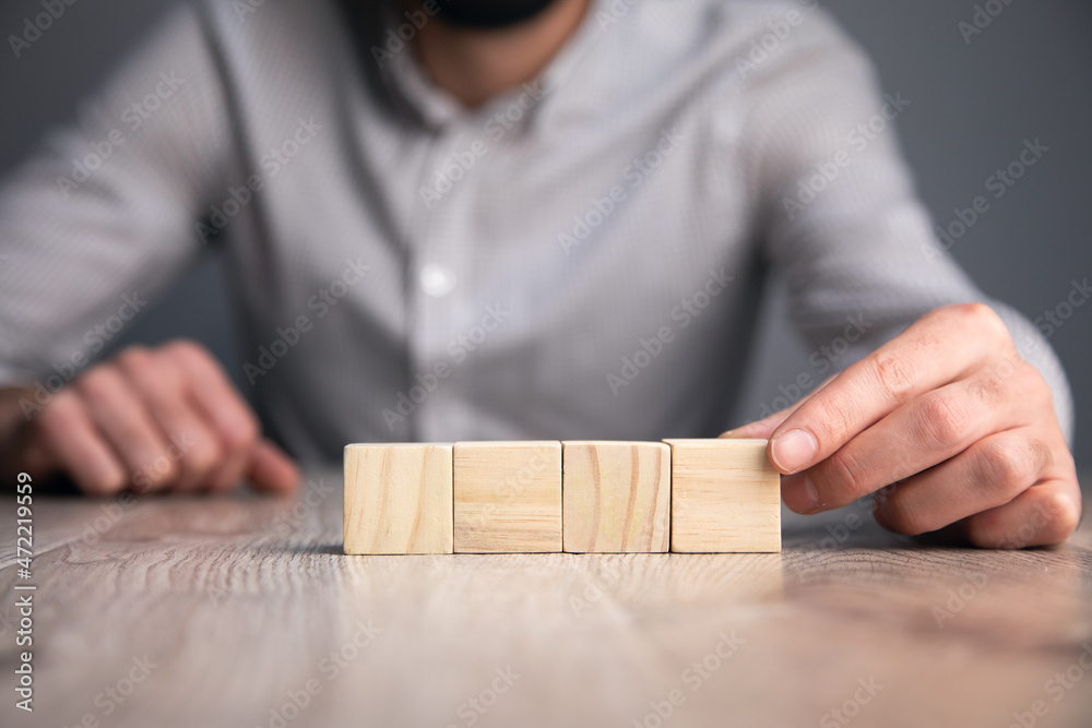 Hand holding blank wooden block cubes Hand holding blank wooden block cubes