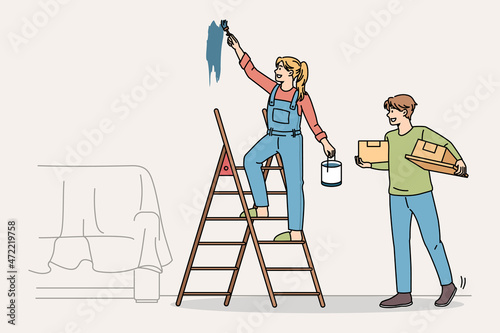 Happy couple do home renovation or decoration together. Smiling man and woman paint walls decorate repair house or apartment. Interior design concept. Vector illustration, cartoon character.