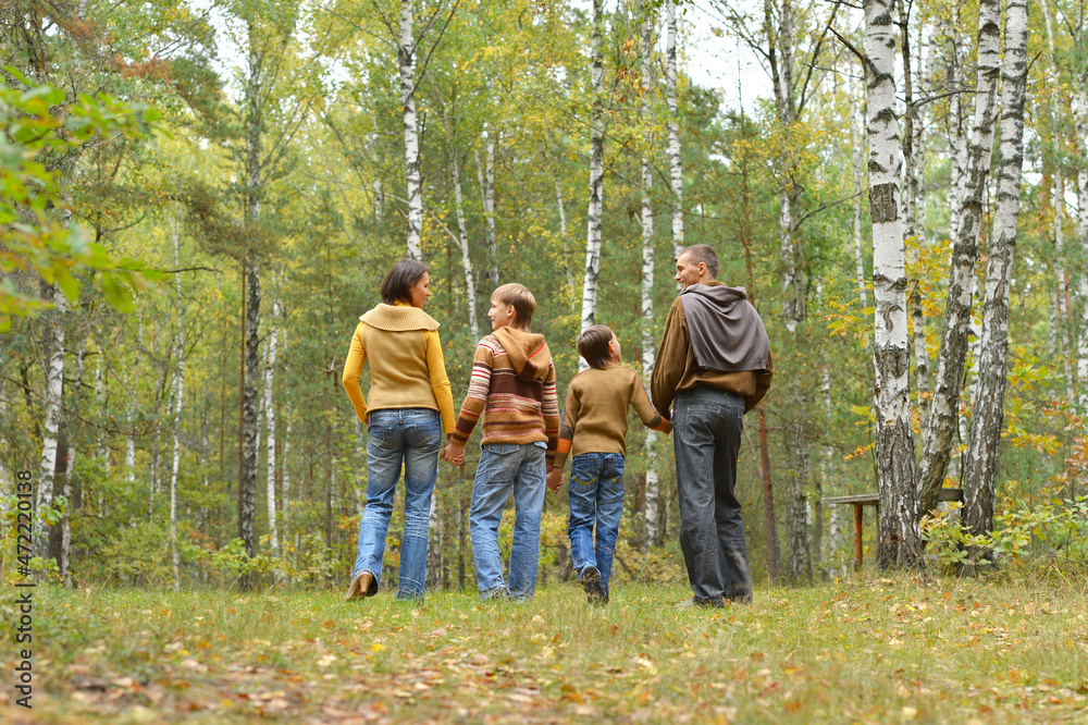 Portrait of family of four in park