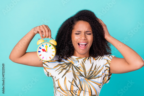 Photo of stressed depressed dark skin woman dressed print blouse holding watch arm head isolated teal color background