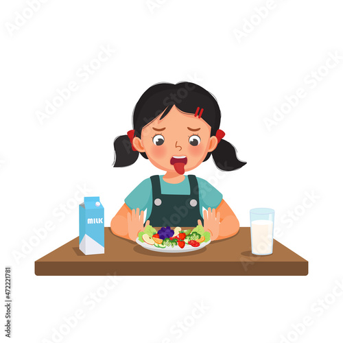 Little girl feeling disgusted for eating fruits and vegetables pushing plate away refusing to eat