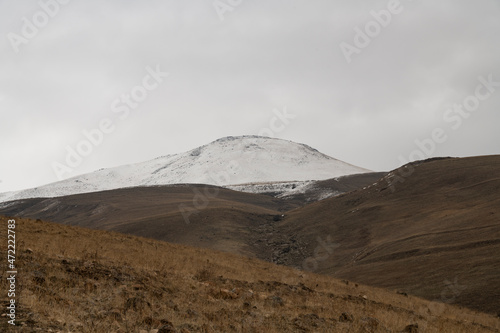 Panoramic view on the snow covered mountains and hills.