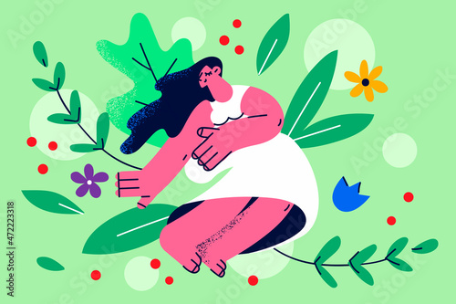 Happy woman sit in flowers field feel calm