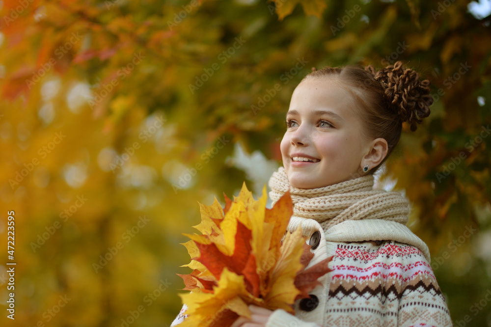 Pretty little girl resting in autumnal park Pretty little girl resting in autumnal park