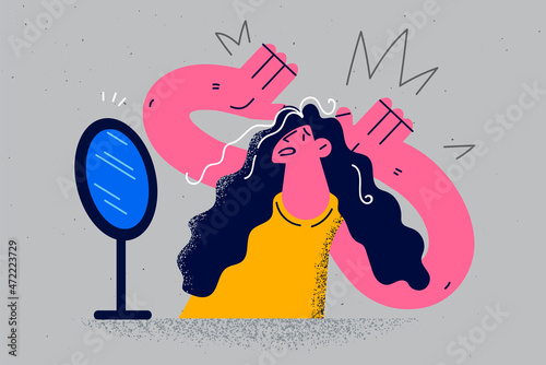 Anxious woman look in mirror stressed with grey hair 
