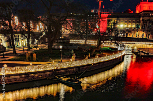 Stockholm, Sweden The Helgeandsholmen island lit up with Christmas lights at night. photo