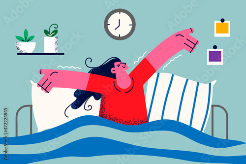 Happy woman wake up in bed at home in morning 