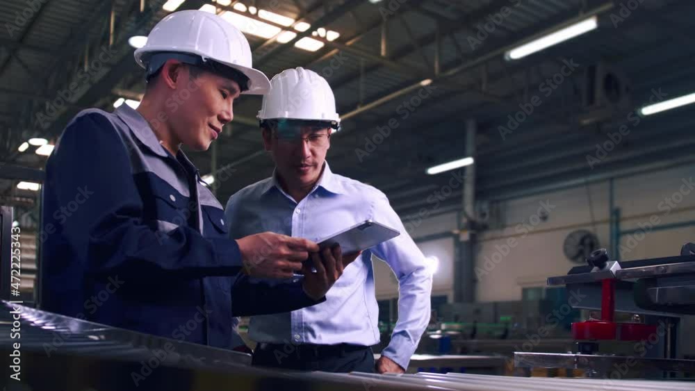 An engineer is explaining remote machine control to industrial owners. An engineer is explaining remote machine control to industrial owners.