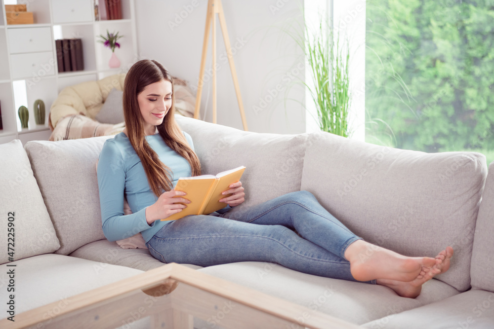 Full length body size photo young woman laying on sofa reading book relaxing Full length body size photo young woman laying on sofa reading book relaxing