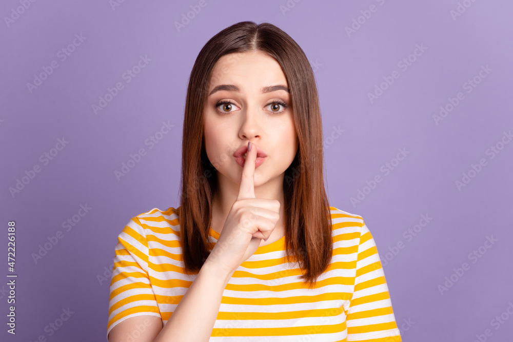 Photo of young lovely girl cover finger lips shh keep secret confidential isolated over violet color background Photo of young lovely girl cover finger lips shh keep secret confidential isolated over violet color background
