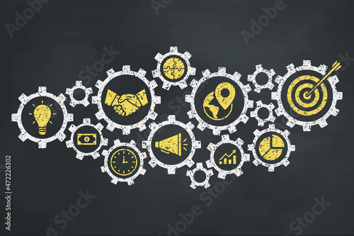 Gear concept with business icons on the blackboard.