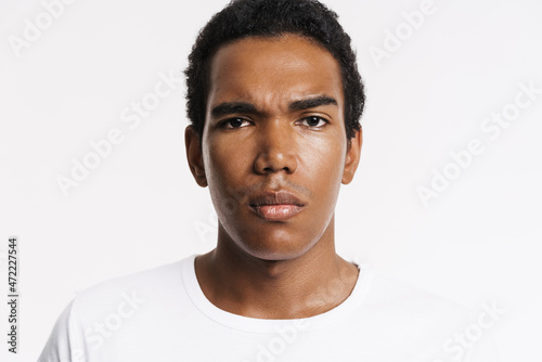 Young black man dressed white t-shirt posing and looking at camera