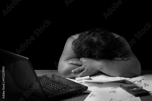Obraz na plátně Small business owner experiences financial crisis, women sitting at desk looks at  receipt feels desperate after calculating expenses, Unable to pay the bank debt, money overspend concept