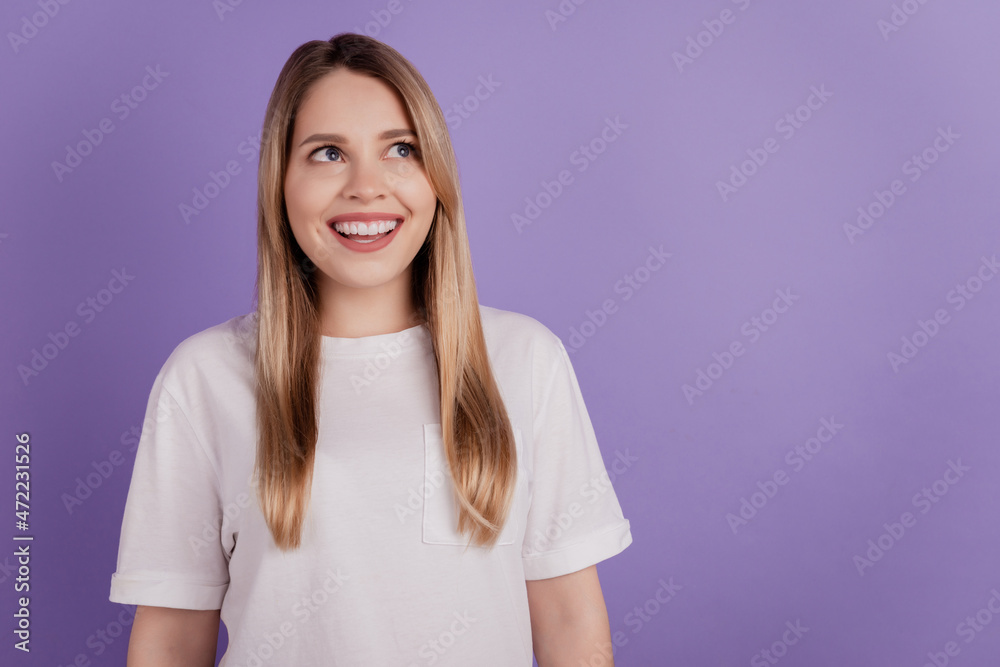Photo of positive interested lady look empty space dream wear casual clothes on violet background Photo of positive interested lady look empty space dream wear casual clothes on violet background