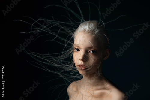 Portrait of a girl with lively curly hair. A young gorgon jellyfish from mythology