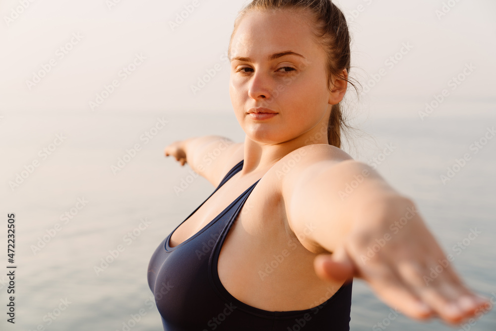 Ginger young woman doing exercise during yoga practice