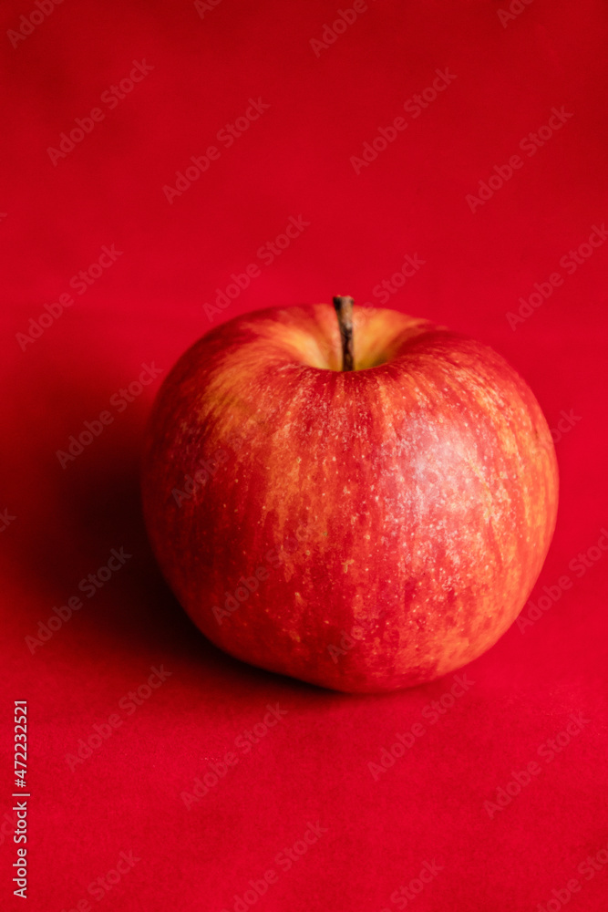 close up fresh red apple on red background close up fresh red apple on red background
