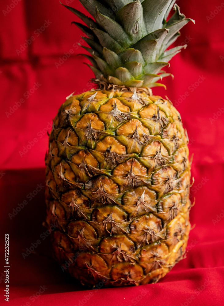 pineapple close up on red background
