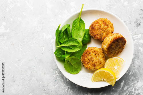 Fish cod potato cakes. Fish fritters with sauces and lemon wedges. Top view