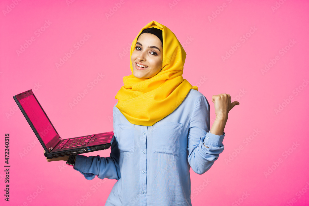 muslim woman in yellow hijab with laptop technology student pink background muslim woman in yellow hijab with laptop technology student pink background